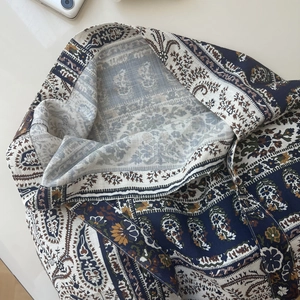 Detail of bohemian paisley cotton bag with intricate stitching and soft fabric texture