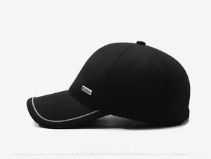 Detail of black winter baseball cap featuring silver reflective brim and Fashion metal tag