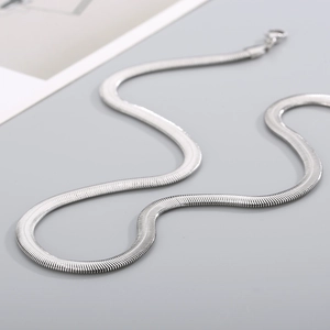 Close-up of a high-polish silver flat snake bone chain necklace with a lobster clasp