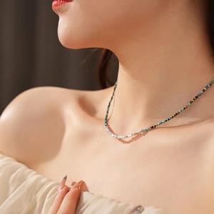 Elegant beaded necklace featuring turquoise stones and irregular silver metallic beads