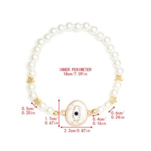 Detail view of pearl beaded evil eye bracelet with size specs and star charms