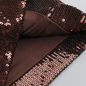 Detailed macro view of dark bronze sequins fabric with elastic knit lining and texture