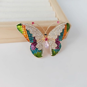 Exquisite colorful butterfly brooch with enamel wings and a pink teardrop crystal
