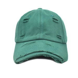 Close-up of dark green baseball cap featuring vintage distressed holes and frayed edges