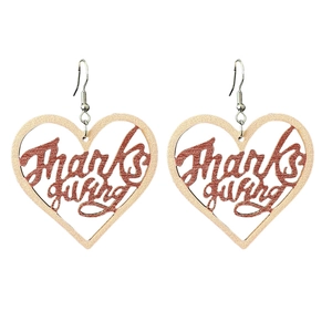 Detailed close-up of heart-shaped wooden earrings with rose gold Thanksgiving cutout