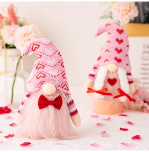 Detail of pink Valentine gnomes with knit hats, red hearts and soft white faux fur beards