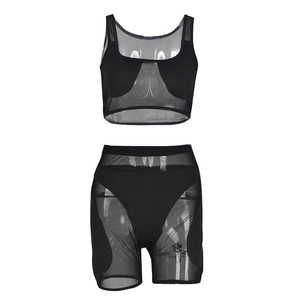 Detail of black mesh two-piece set featuring cutout tank top and high-waisted shorts