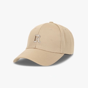 Close-up of the silver R letter embroidery and fine texture on a khaki baseball cap