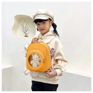 Detail view of yellow toddler backpack with cute cat window and white plush toy interior