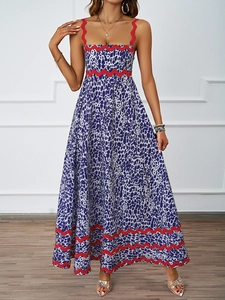 Detail of summer vacation maxi dress with blue leopard print and red wavy strap detail