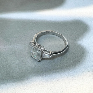 Macro detail of S925 sterling silver stamp on emerald cut moissanite ring band