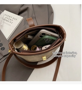 Top view of brown bucket bag interior showing spacious capacity and inner zipper pocket