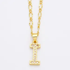 Detailed macro view of gold letter I pendant with micro-pave cubic zirconia on Figaro chain