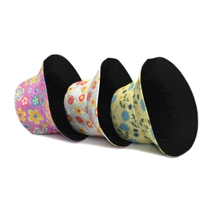 Reversible floral bucket hat for sun protection featuring colorful patterns and black lining