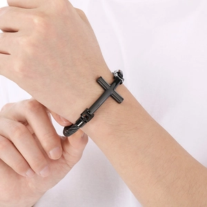 Close-up of black stainless steel cross bracelet with a durable braided twist band