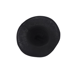 Top view detail of the wide-brimmed black woven witch hat with a wavy sunshade edge