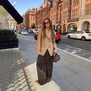 Women's khaki oversized blazer with leopard print trousers in an urban street setting