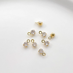 Macro view of gold-plated cubic zirconia charms for DIY jewelry making and crafting