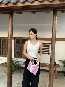 Close-up of handmade purple and white cotton rope woven tote bag with hollow patterns