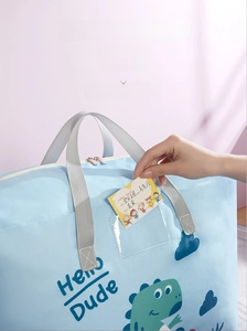 Detail of kindergarten storage bag showing transparent PVC label pocket and dinosaur design