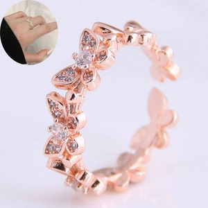 Detail of rose gold open ring featuring zircon-encrusted butterfly and floral design