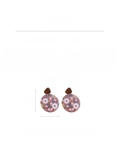 Detail of round wooden floral earrings with 5.5cm height and silver needle posts