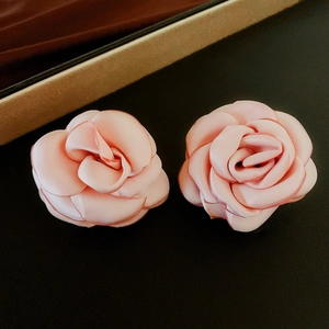 Close-up of pink flocked rose floral jewelry with delicate silk petals and texture