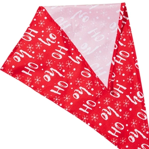 Detail of red Christmas pet bandana with Ho Ho Ho and snowflake print on fabric