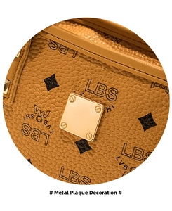 Detail of lychee textured leather bucket bag with gold logo plaque and monogram pattern