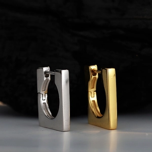 Minimalist square hoop earrings in silver and gold finish on a dark stone background
