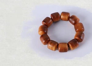 Macro shot of polished yellow wood prayer beads with natural fine grain and glossy finish