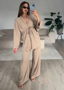 Detail of beige long sleeve tie-waist top and matching wide leg pants set for women