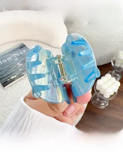 Close-up of Aurora blue acetate hair claw clip with iridescent finish and metal spring