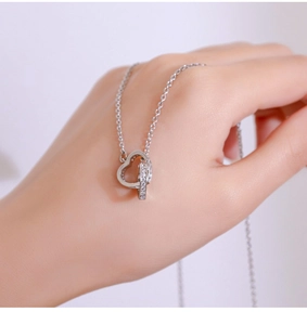 Macro shot of silver interlocking heart and circle pendant with pave cubic zirconia