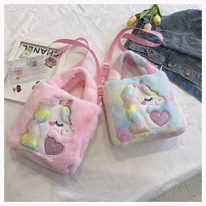 Detail view of pink and rainbow unicorn plush handbags with soft faux fur and embroidery