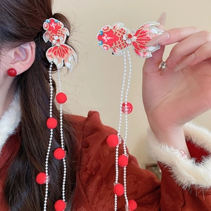 Close-up of embroidered red koi fish hair clip with long pearl tassels and soft pompoms