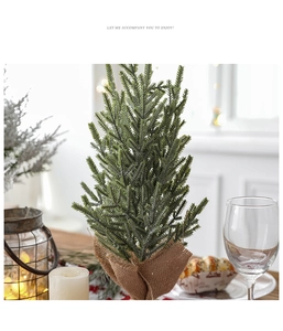 Mini artificial pine Christmas tree with burlap base in a cozy holiday home setting