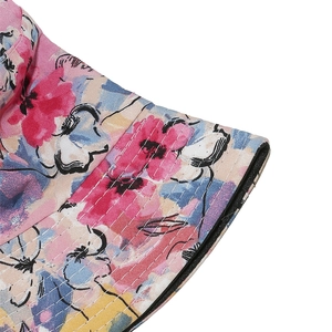 Detail of pink floral sun hat showing precision stitching and reinforced brim texture
