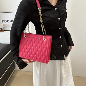 Hot pink quilted crossbody bag with golden chain strap for women in trendy diamond pattern
