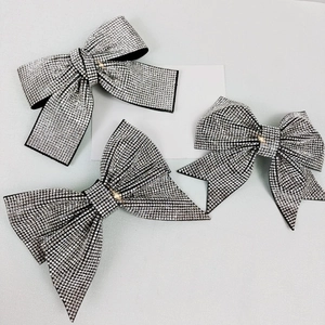 Sparkling crystal bow hair clips with silver rhinestones on elegant black base