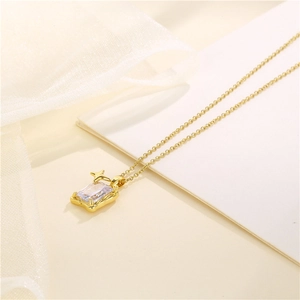 Gold stainless steel rectangle pendant necklace with zircon and star detail on beige background