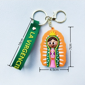 Cartoon Virgencita keychain with green silicone wrist strap and pink religious charm