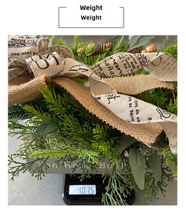 Detail showing a rustic Christmas wreath with greenery on a scale weighing 407.5g