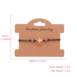 Adjustable woven black rope bracelet featuring a golden airplane pendant on a brown card