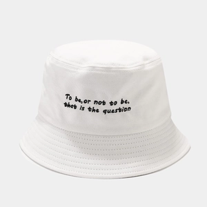 Close-up of white cotton bucket hat featuring black embroidered Shakespearean quote