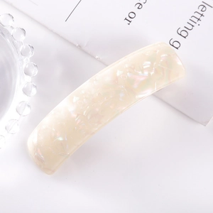 Close-up of rectangle spring hair clip in pearlescent cream acetate with shell texture