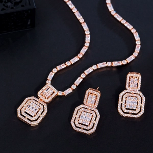 Macro view of rose gold layered octagonal jewelry set with white cubic zirconia crystals