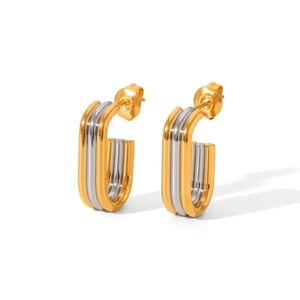 Close-up of dual-tone gold and silver U-shaped stainless steel earrings with mirror finish
