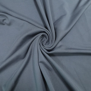 Detailed view of grey textured fabric showing soft folds and fine textile grain