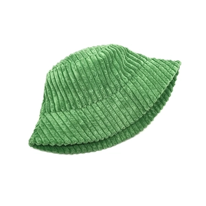 Close-up of green corduroy bucket hat texture showing high-quality vertical ribbing